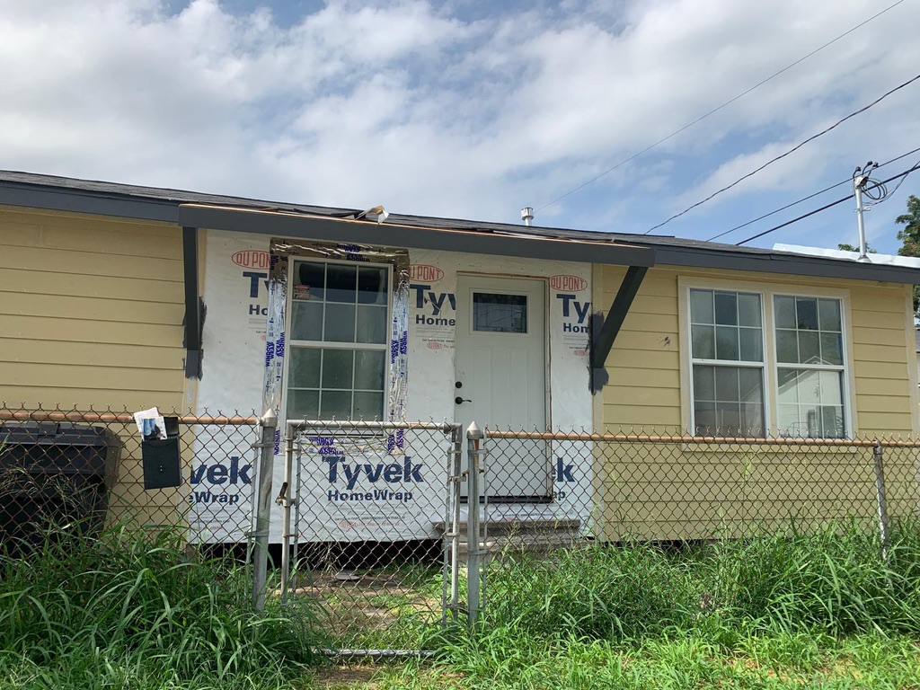 1509 exterior before remodeling with exposed Tyvek